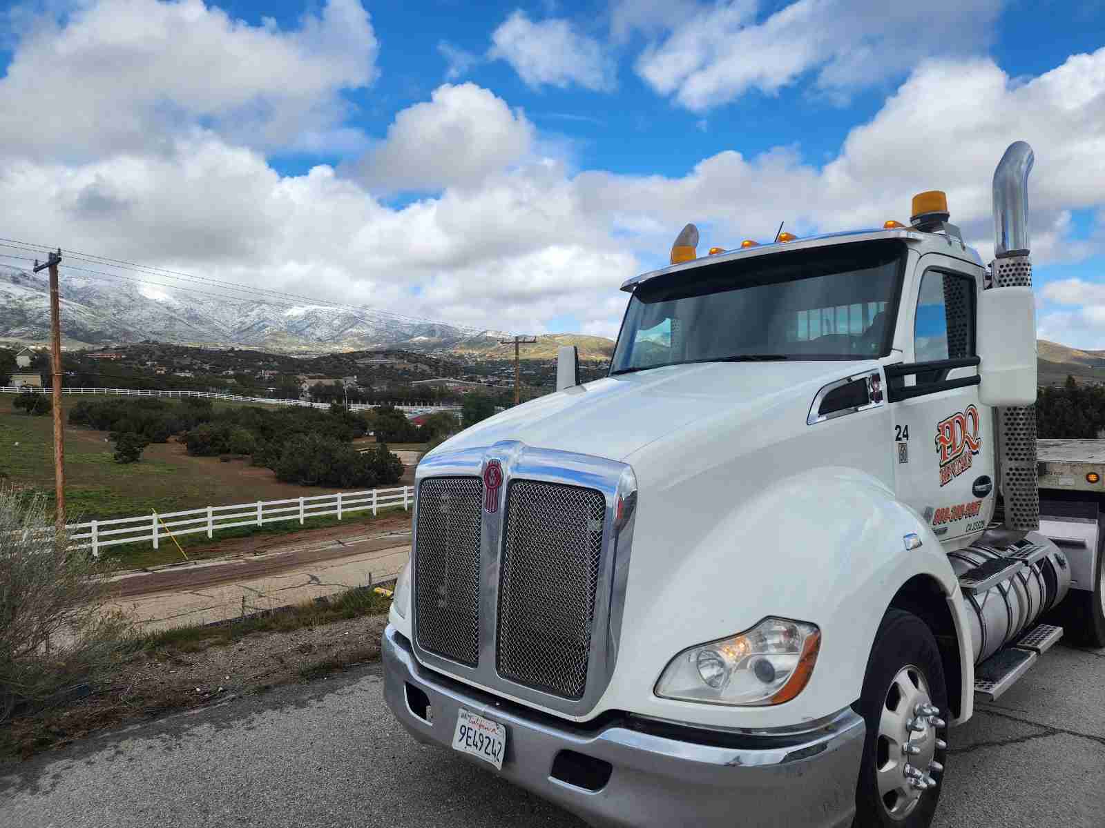 PDQ delivery truck parked at a ranch property