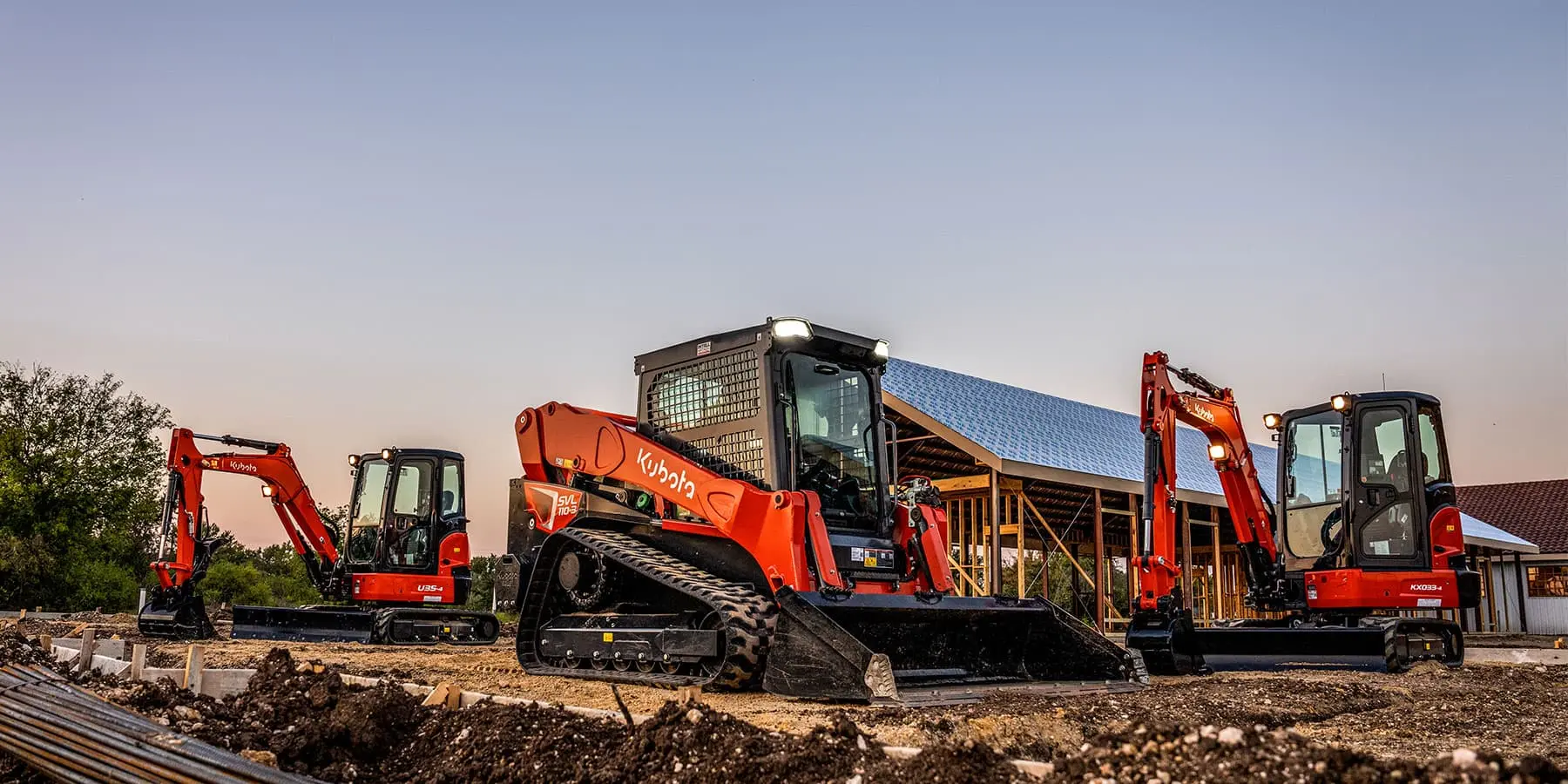 A Kubota SVL track loader and Kubota mini excavators lined up