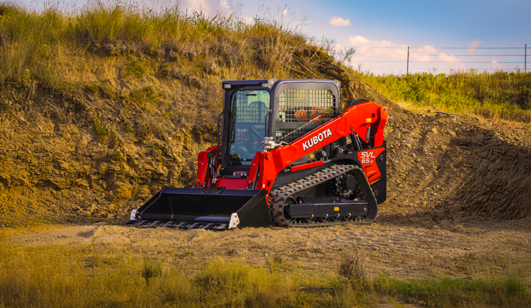 Kubota SVL65 compact track loader on a dirt slope