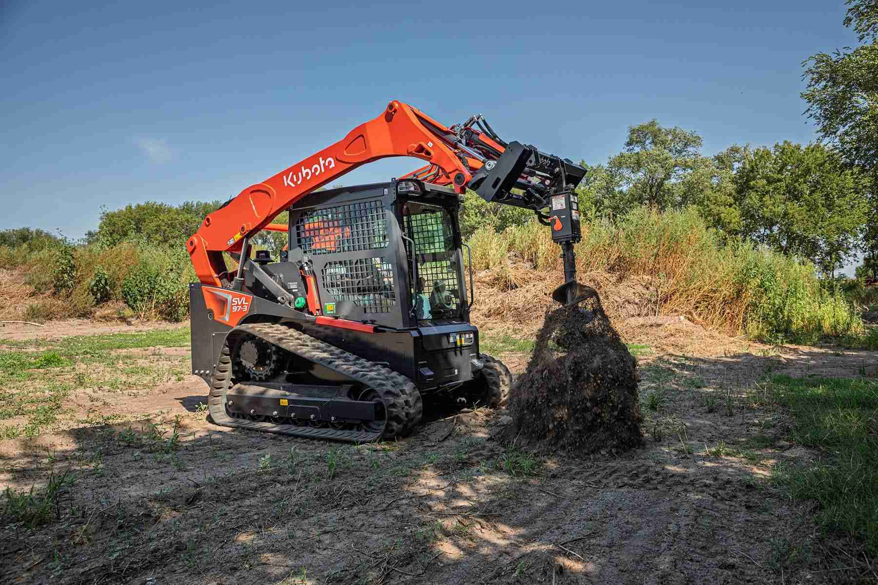 Kubota track loader pulling an auger out of the soil