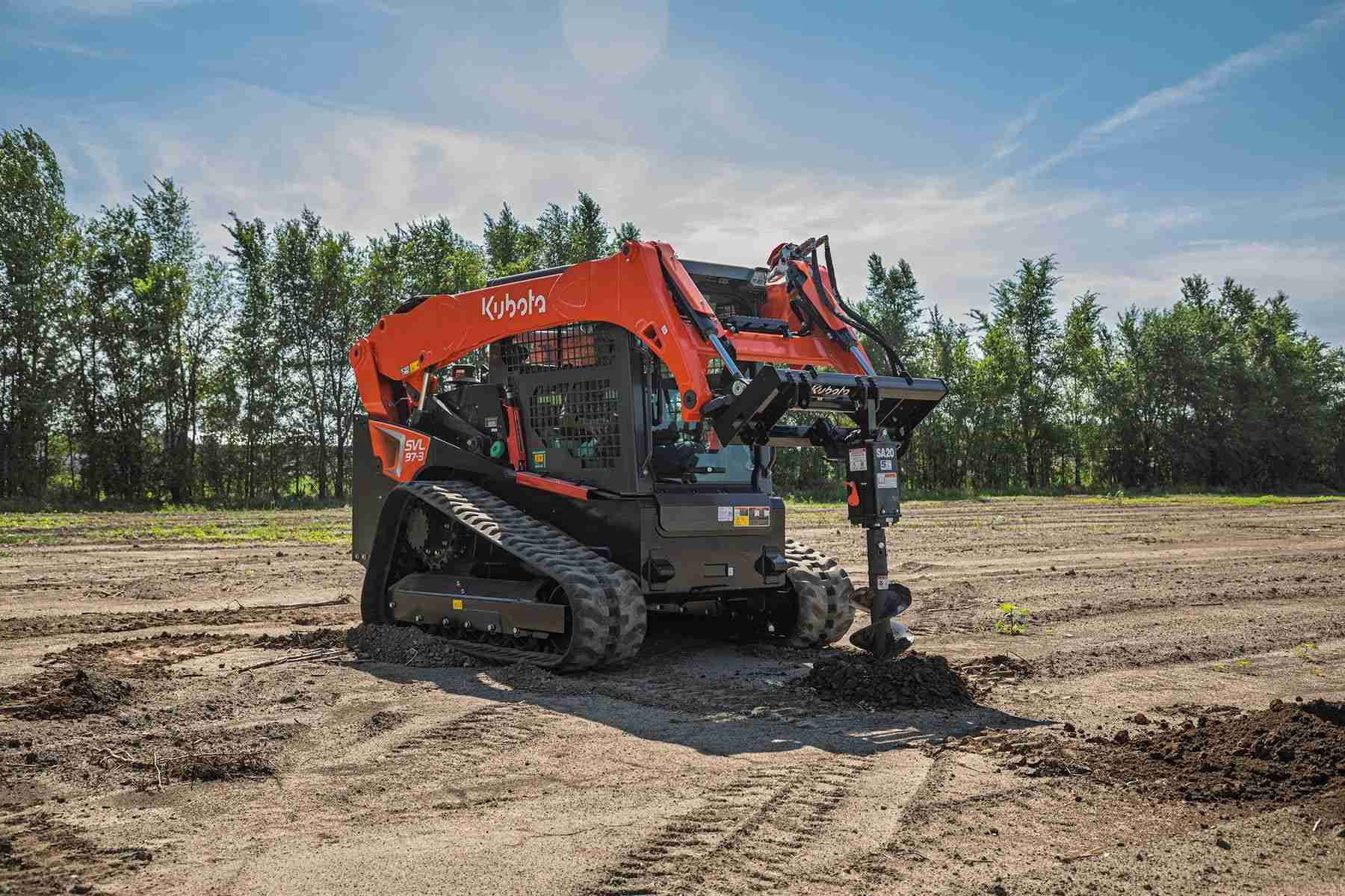 Kubota track loader drilling a hole with an auger
