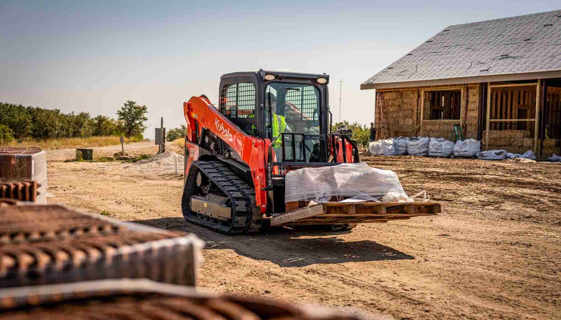 Kubota track loader carrying a pallet on pallet forks